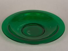 A Peking green glass charger Of large dished form. 40 cm diameter.