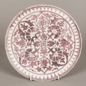 An antique, possibly early Persian, pottery plate Of circular footed form,