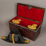 A cased set of early 20th century Royal Naval bicorn hat and epaulettes by Gieves of London Hat
