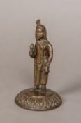 A 19th century Indian patinated bronze figure Modelled standing in flowing robes and a headdress,