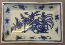 A Chinese blue and white porcelain dish Centrally worked with rockwork issuing floral sprays within