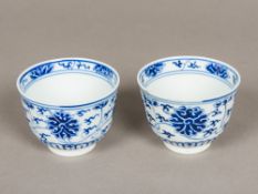 A pair of Chinese blue and white porcelain tea bowls Both decorated with lotus strapwork,