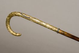 A 19th century Austro-Hungarian sapphire set silver gilt handled walking cane The florally scroll