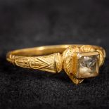 An early, possibly Medieval, unmarked gold stone set ring Of heart form, with half engraved shank.