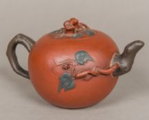 A Chinese Yixing teapot Of ovoid form, with scrolling branch decorations,