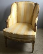 A 19th century giltwood framed upholstered armchair The bead and floral carved shaped back above