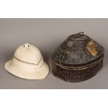 An early 20th century pith helmet by Gieves of London In original mottled tole ware case.
