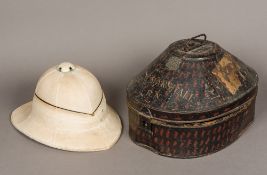 An early 20th century pith helmet by Gieves of London In original mottled tole ware case.