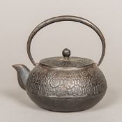 A 19th century Japanese cast iron teapot Decorated in the round with chrysanthemum,