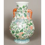 A Chinese porcelain vase Of spreading bulbous form with twin elephant mask handles,