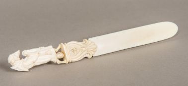 A 19th century Dieppe ivory page turner The finial carved as a fox in monk's costume. 28 cm long.