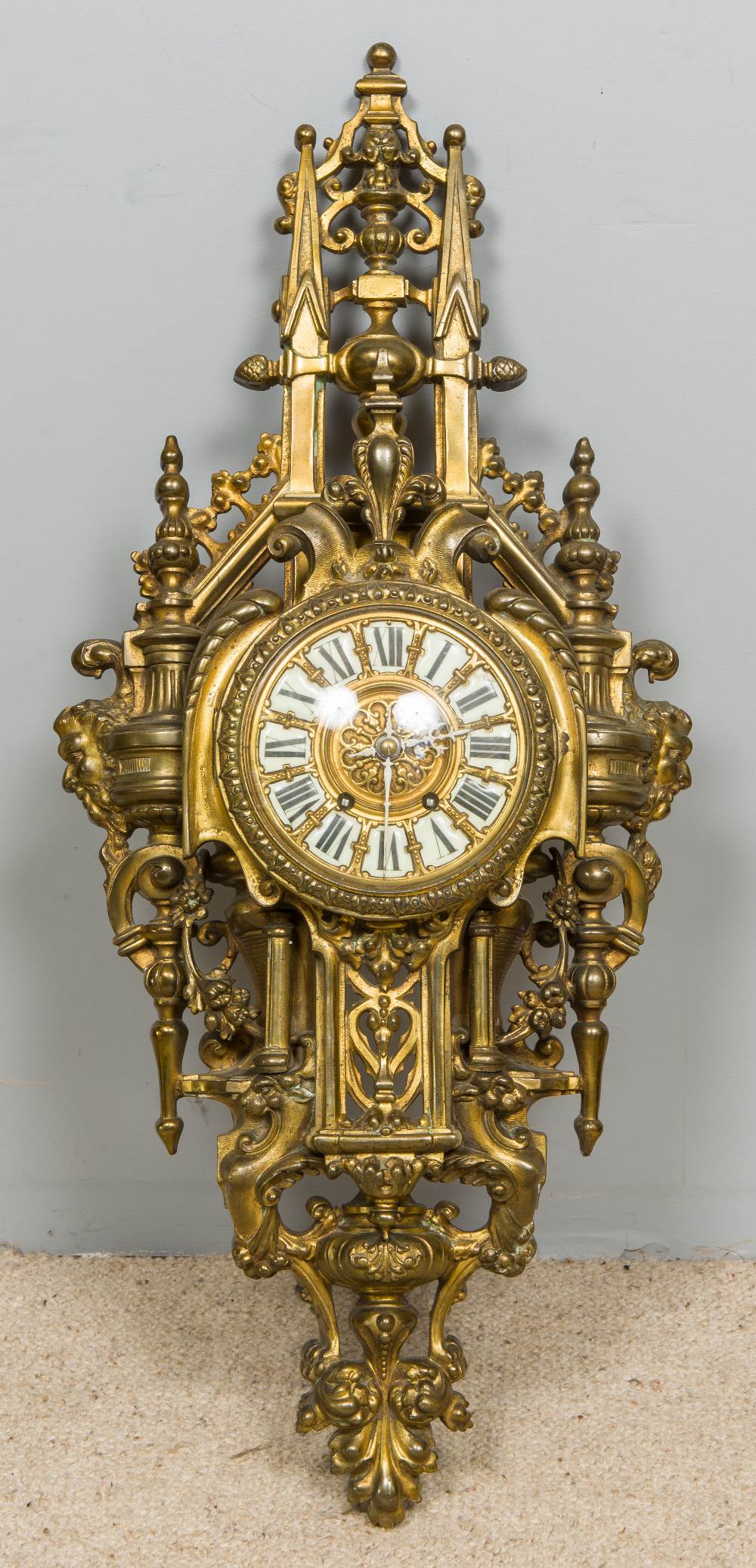 A gilt brass cased cartel clock Of large pierced architectural form,