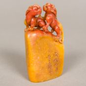 A Chinese carved Shoushan stone seal Surmounted with a pair of temple lions and worked with