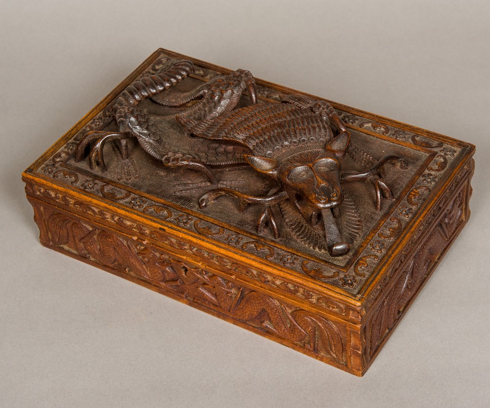 A late 19th century Eastern carved wooden box Of rectangular hinged form,