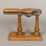 A Victorian silver plate mounted oak lemon squeezer Of typical form, with hinged straining section.