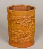 A Chinese carved bamboo brush pot Decorated with ducks amongst lilies. 16.5 cm high.