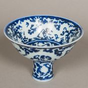 A Chinese blue and white porcelain stem cup Decorated to the interior and exterior with incised