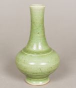 A Chinese porcelain vase With allover celadon glaze and moulded band decoration. 16 cm high.