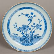 An 18th century Chinese blue and white porcelain dish Centred with flowering stems in a fenced