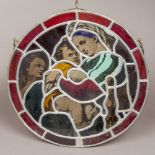 A lidded stained glass roundel depicting the Madonna and child,