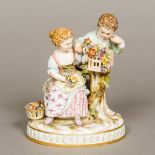 A 19th century Meissen porcelain figural group Modelled as two young children with a nesting chick,