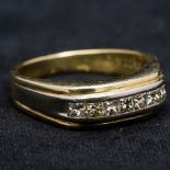 An 18 ct gold and diamond ring Set with a single band of diamonds totalling approximately 0.