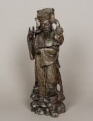 A Chinese carved hardwood figure of a deity Modelled holding a ruyi sceptre,