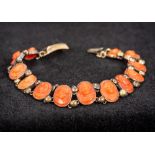 A small carved coral cameo bracelet 15 cm long.