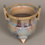 A Chinese pottery censer Of squat twin handled form, with blue and purple glaze. 12.5 cm high.