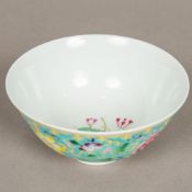 A Chinese porcelain bowl Worked with lotus strapwork on a turquoise ground,