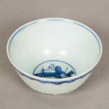 A Chinese blue and white porcelain tea bowl Decorated with incised stylised waves,