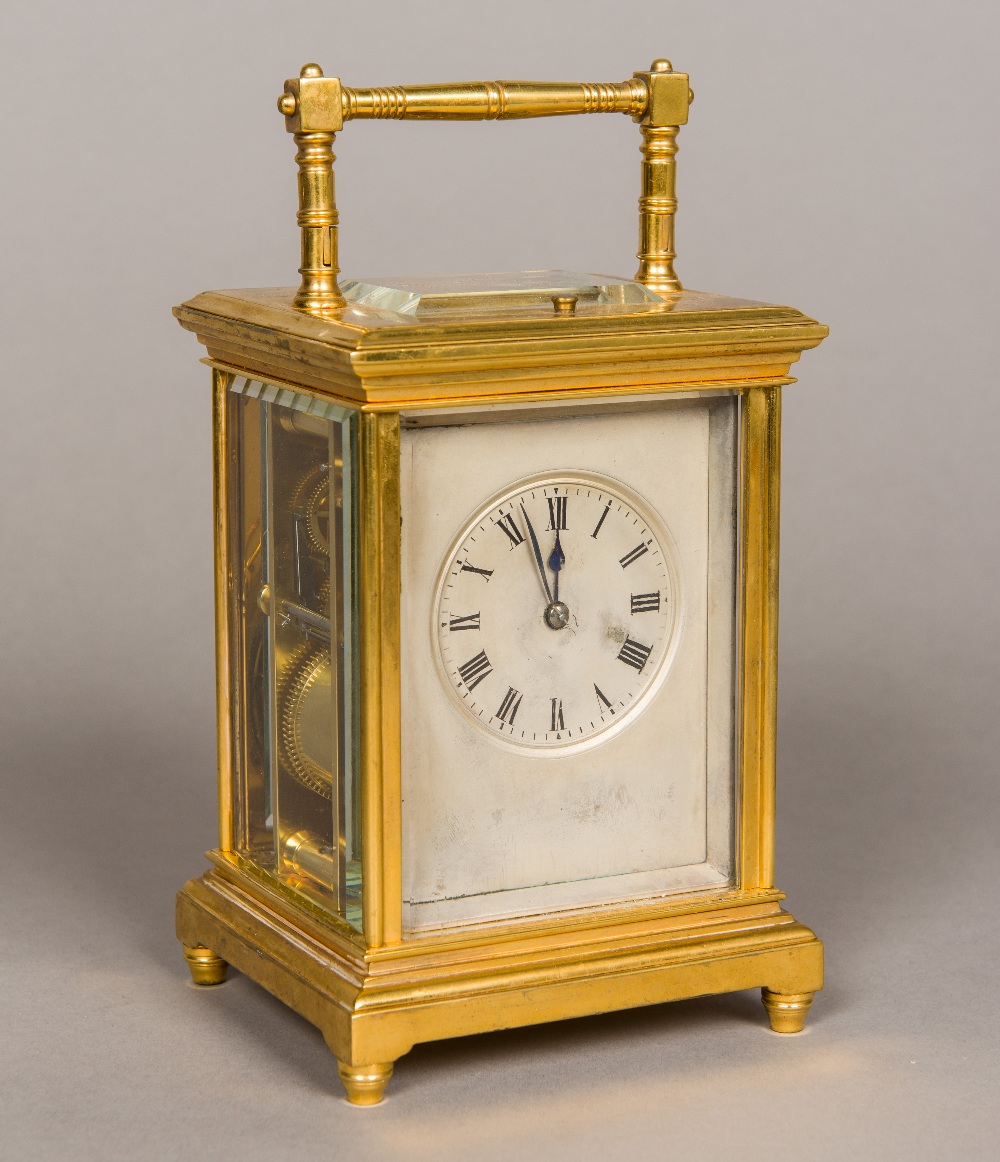 A lacquered brass cased repeating carriage clock With turned loop handle and silvered dial with