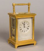 A lacquered brass cased repeating carriage clock With turned loop handle and silvered dial with