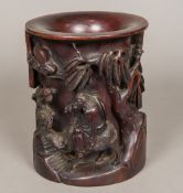 A Chinese carved hardwood brush pot Worked with a figure riding a water buffalo in a continuous