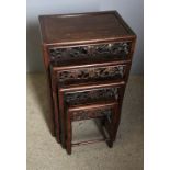 A late 19th century Chinese carved hardwood quartetto nest of tables Each rectangular panelled top
