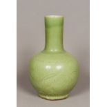 A Chinese celadon ground pottery vase The plain elongated neck above the bulbous body with