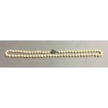 A single strand Sakata Ltd pearl necklace 62 cm long.