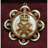 A Victorian unmarked gold, diamond and enamel pendant/brooch Of pierced lobed circular form,