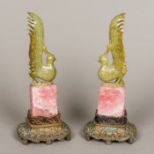 A pair of Chinese jade and rose quartz carvings Each formed as a jade bird atop a carved rose