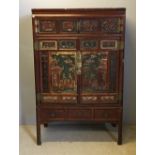 A late 19th century Chinese carved wooden cabinet on stand The top section with two small doors and