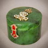 An enamel diamond, emerald and ruby set spinach jade box Of small cylindrical form,