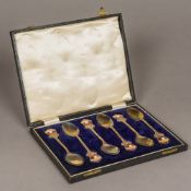 A cased set of six George V enamel decorated silver teaspoons, hallmarked Birmingham 1935,