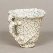 A Chinese crackle glaze libation cup Of typical form, with allover white ground. 7.5 cm high.
