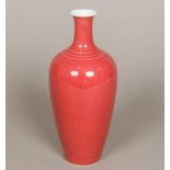 A small Chinese porcelain vase Of slender tapering bulbous form, with allover red glaze,