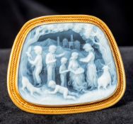 An unmarked 18 ct gold mounted hardstone cameo brooch Carved with figures and animals in a