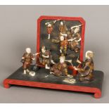 A fine quality Japanese Meiji period ivory and lacquer figural group Formed as a group of artists