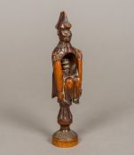 A 19th century treen nutcracker Modelled as a seated admiral above the turned screw. 16 cm high.