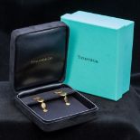 A pair of Tiffany & Co. 18 ct gold earrings Each of beaten circular drop form, boxed. Each 4.