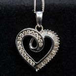 An 18 ct white gold diamond set pendant and chain Formed as a heart. The pendant 2.5 cm high.