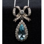 An 18 ct white gold diamond and aquamarine set pendant necklace Set as a bow tied drop.